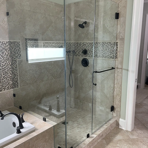 Shower enclosure with tiles and glass doors by Dunn's Flooring Depot