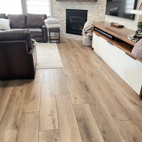 Flooring installation wide plank flooring in living room with fireplace