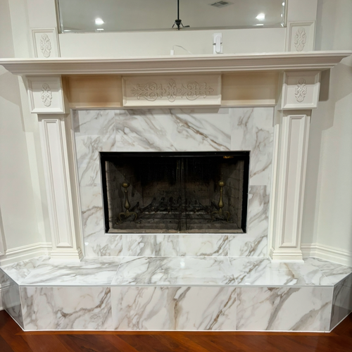 Custom glass and Tile Fireplace under the stairs by Dunn's Flooring Depot Showroom & Design